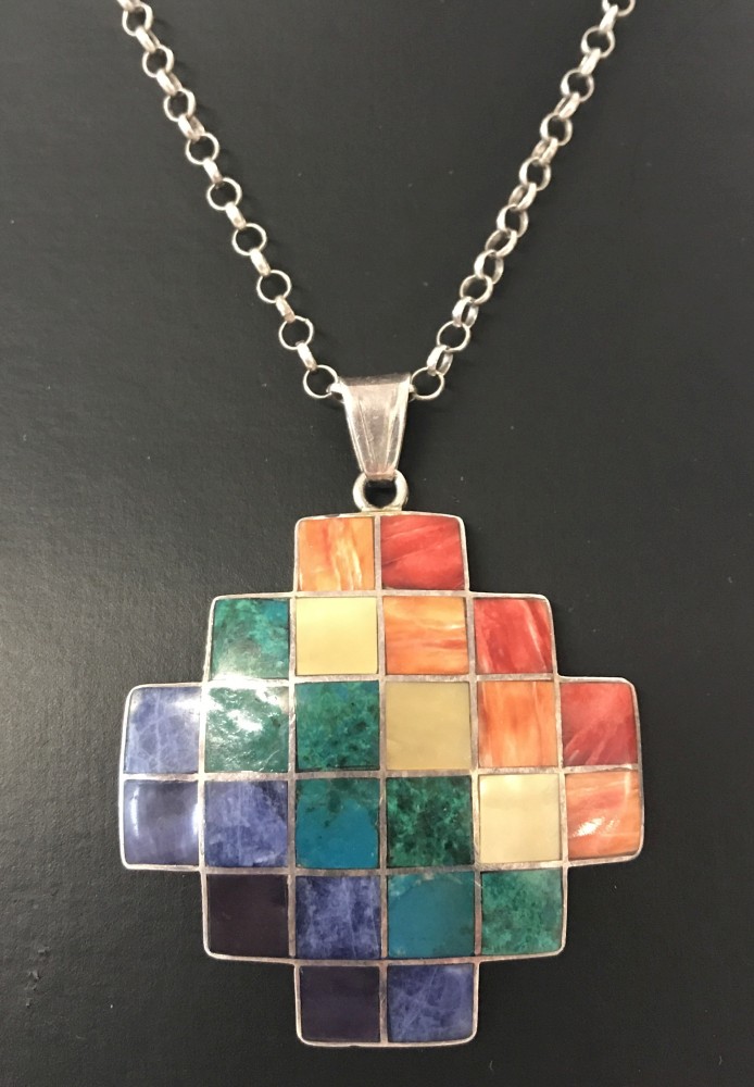 A large silver modern design pendant set with small squares of natural stone on a 22" belcher chain.