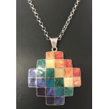 A large silver modern design pendant set with small squares of natural stone on a 22" belcher chain.