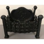 A vintage cast iron fire grate with rampant horse design to back panel.