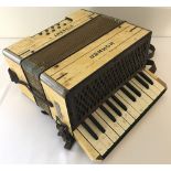 A vintage German Hohner Student 1 accordion with cream marbled effect veneer.