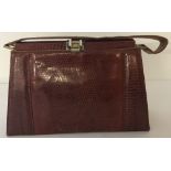 A vintage 1950's lizard skin Kelly handbag with soft leather interior.