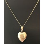 A 9ct gold front and back heart shaped locket on a 18 inch 9ct gold fine curb chain.