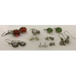 8 pairs of silver and white metal stud and drop style earrings.