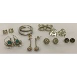 8 pairs of silver and white metal stud and drop earrings.