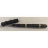 A vintage Waterman's Ideal No 52 green fountain pen with 9ct gold banding.