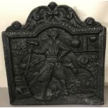 A vintage cast Iron fire back with Foundry man design and Latin inscription.