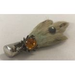 A silver and rabbits foot brooch with stag head and citrine coloured stone.