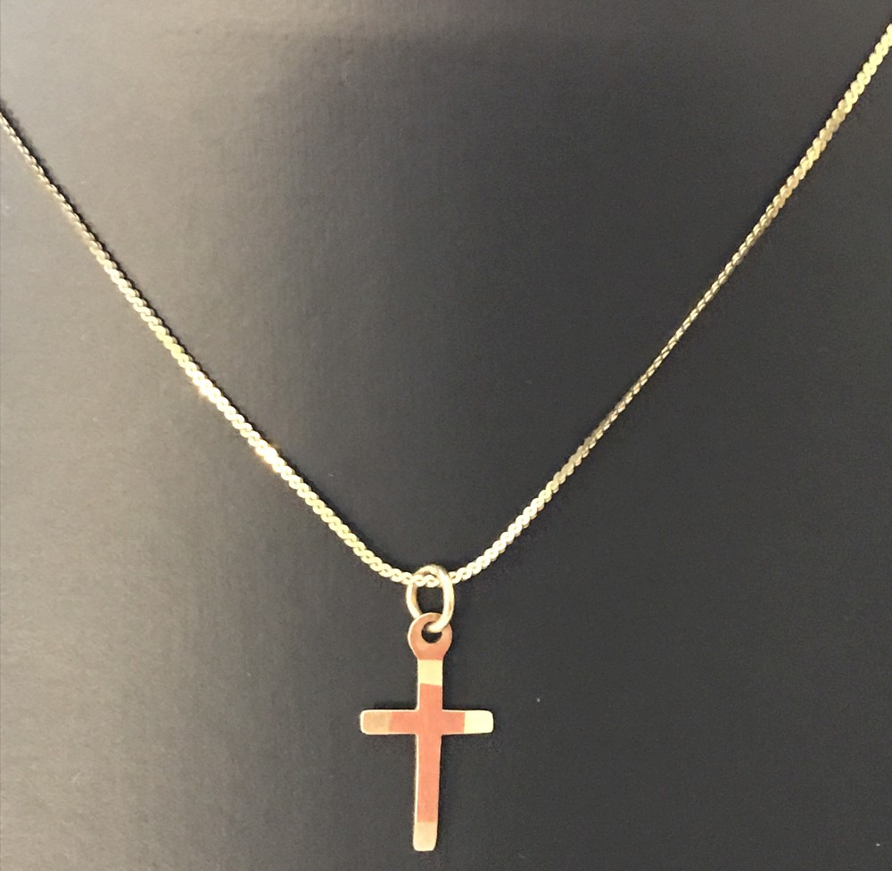 A small 9ct gold cross on a 14inch 9ct gold serpentine chain.