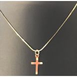 A small 9ct gold cross on a 14inch 9ct gold serpentine chain.