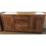 A solid light wood sideboard with 4 central drawers and 2 cupboards.