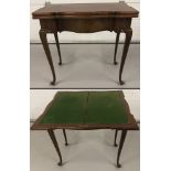 An ornately shaped wooden games table with cabriole style legs and swivel top.