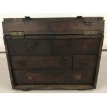 A vintage dark wood Engineers chest with front opening lid and 5 interior drawers.