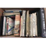 A box of assorted vintage car manuals and maps.