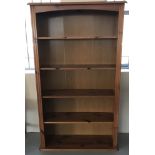 A honey coloured pine 4 shelf bookcase.