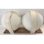 A pair of vintage Holophane ball shaped light shades in white opaque glass.