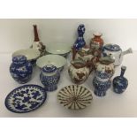 A collection of oriental ceramic items to include vases, teapots, ginger jars and bowls.