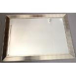 A modern rectangular mirror with subdued gold and silver striped frame.