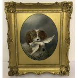 A gilt framed oil on board depicting a working dog with his find.