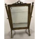 A Victorian wooden framed dressing table swing mirror painted gold.
