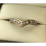 A ladies wishbone ring with .25ct channel set diamonds.