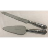 A silver handled bread knife and pie server with Queen's patterned handles.