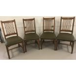 A set of 4 solid oak spindle back dining chairs.