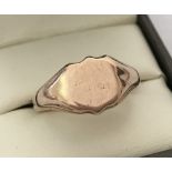 A 9ct gold signet ring with empty shield shaped cartouche.