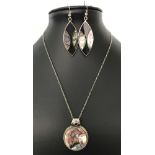 A 925 silver round pendant set with abalone shell and a round garnet, on an 18 inch silver chain.