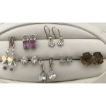 7 Pairs of silver stud and drop style earrings to include pair set with pink sapphires.