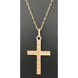 A 9ct gold cross pendant on an 18 inch fine belcher chain.