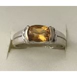 An 18ct gold citrine and clear stone ladies dress ring.