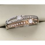 A modern design dual colour 18ct gold and diamond dress ring.