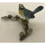 A small cold painted bronze figure of a Blue Tit sitting on a sprig of pussy willow.