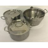 A pair of large stainless steel lidded pans together with a jam pan.