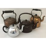 A small collection of metal ware teapots and kettles.