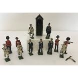A collection of 12 Britains pre war lead soldiers together with a sentry box.