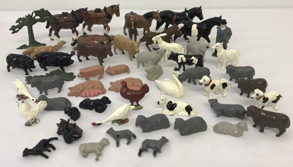 A collection of vintage lead & hollow cast metal farm and farm animal figures.