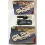 2 boxed vintage Jolly Roger Toys battery operated radio control Porsche 911 Turbo cars.