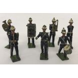 A collection of 7 Britains pre war lead toy soldiers from the Royal Marines Marching Band.