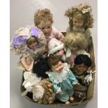 A box of modern ceramic collectors dolls.
