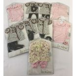A collection of 9 Anita La Nina small doll dresses & outfits. All in original packaging.
