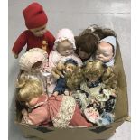 A box of modern ceramic collectors dolls to include sleeping babies and crawling baby with pillow.