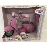 A brand new boxed Zapf Creations Baby Born remote control Vespa style scooter.