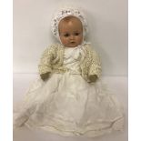 A large soft body vintage doll with Armand Marseille composition head.