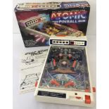 A boxed 1980's electronic table top Atomic Pinball game by Tomy.