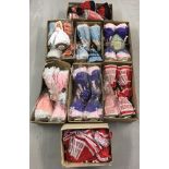 7 boxes containing 31 vintage musical dolls together with a box of 25 dresses with matching hats.