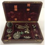 A vintage leather manicure box containing a quantity of vintage costume jewellery.