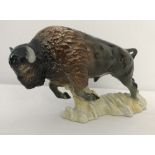 A ceramic figure of a charging bull bison by Goebel #CW38.