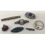 A small collection of silver and white metal brooches , some stone set.