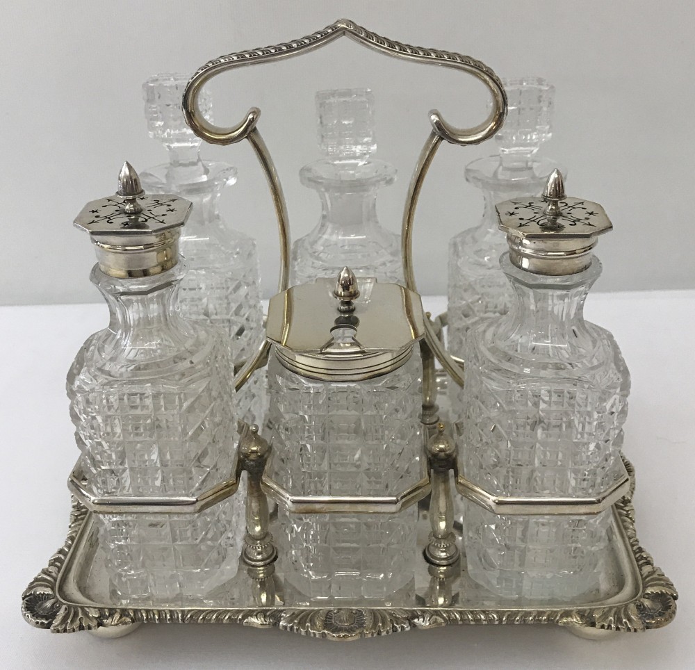 A vintage cut glass and silver plated Atkins Brothers 6 bottle cruet set and frame.